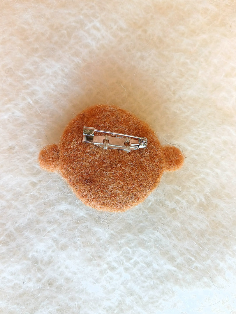 Steel brooch back sewn onto the back of the brooch using colour matched thread.