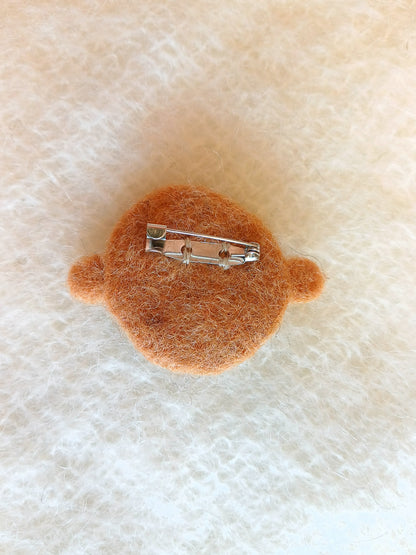 Steel brooch back sewn onto the back of the brooch using colour matched thread.