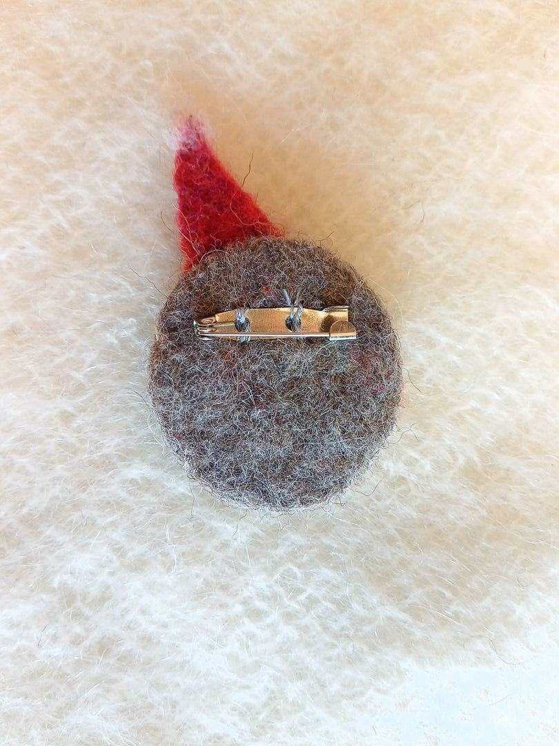 Back of needle felted clown brooch, with a steel c-clasp pin sewn with colour matched thread.