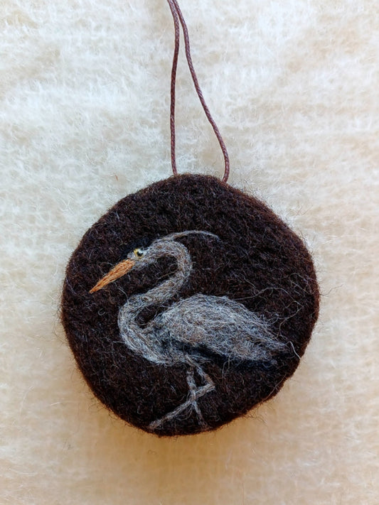 Round brown needle felted hanging decoration with a British heron design. Perfect gift for birdwatchers and nature lovers.